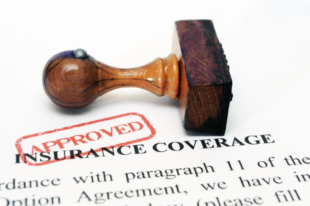 an image of a stamp laying on insurance papers | Insurance Dentist Evansville IN