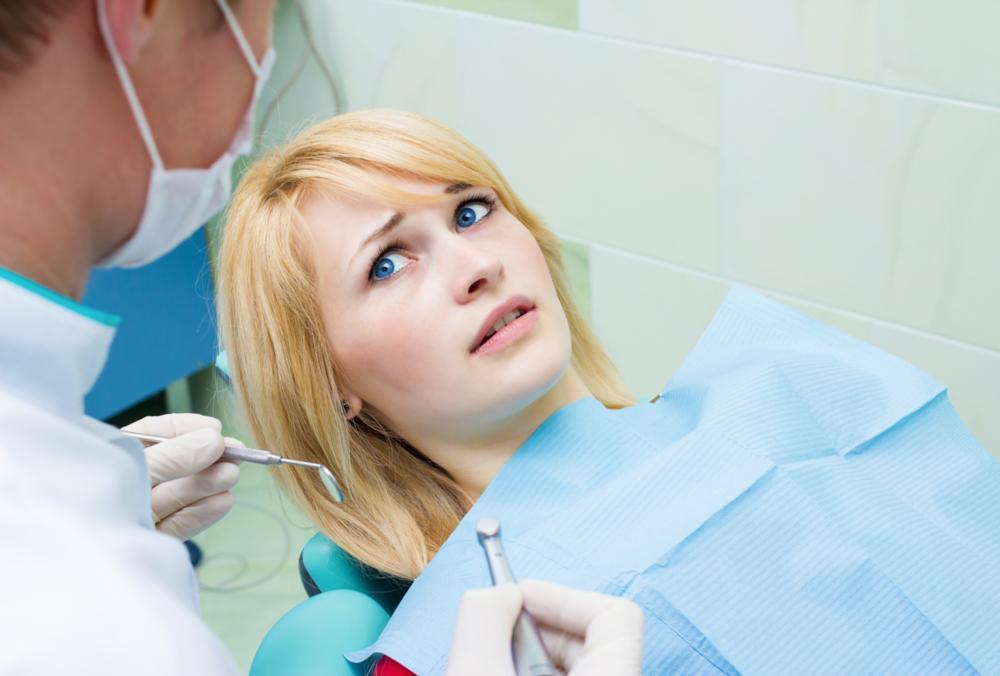 a woman looks concerned in the dental chair 
