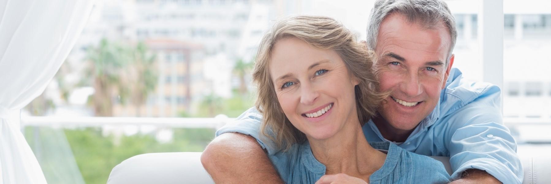Older couple smiling outside l Dentist Evansville IN