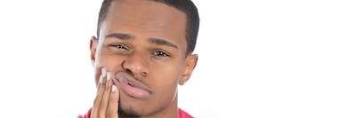 Black man in Evansville IN tightening his right cheek with tooth ache.