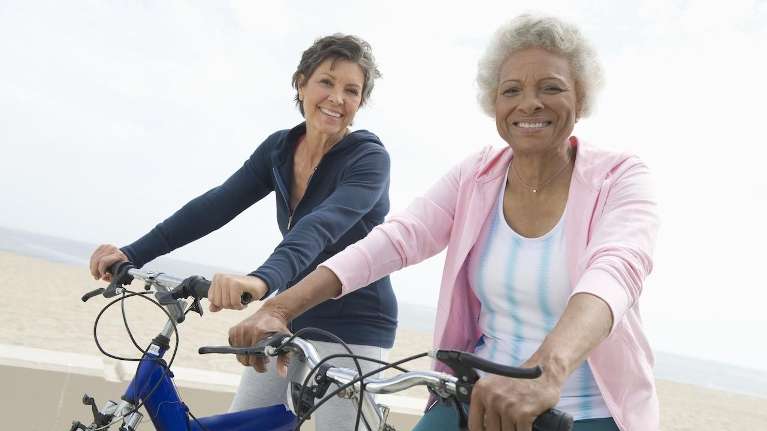 riding a bicycle with a big smile on their face