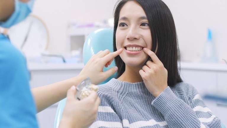Dentist in Evansville IN checking the female patent for implant