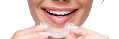 Woman in Evansville IN holding her mouth guard | Bruxism