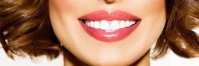 Woman smiling with her front implant teeth in Evansville IN