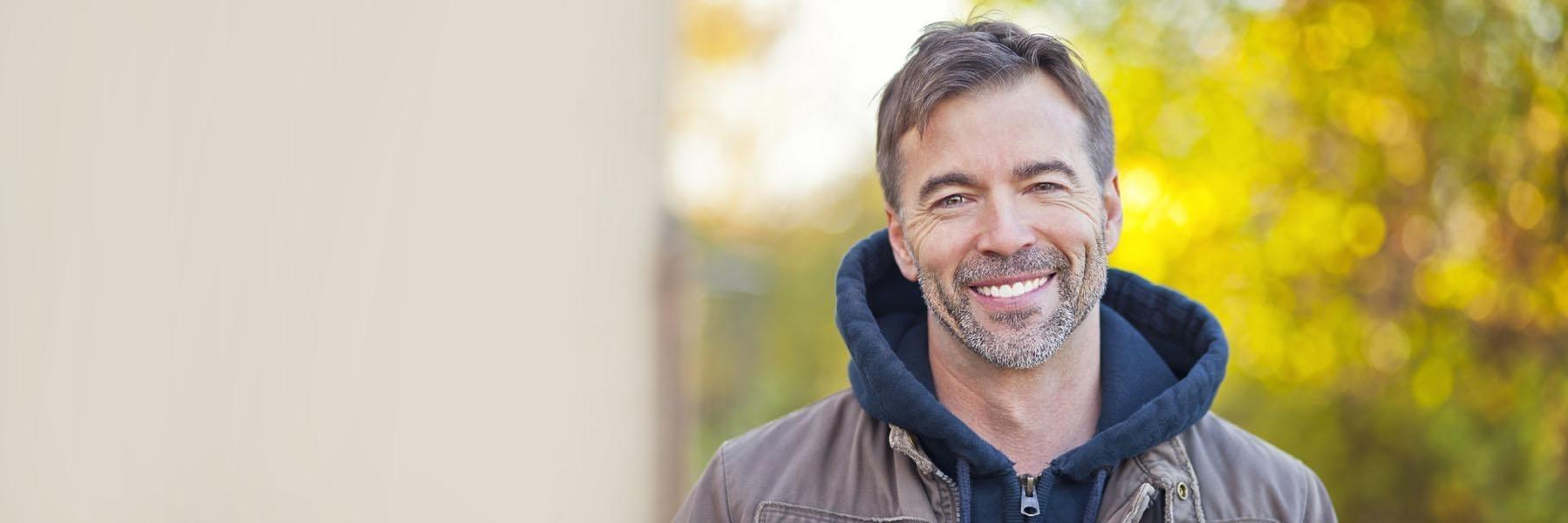 Salt and pepper haired man smiling