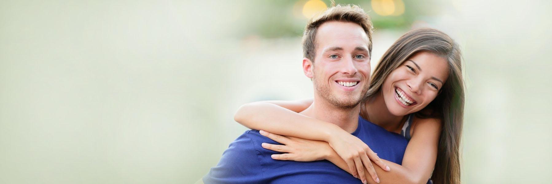 Young couple laughing & smiling 