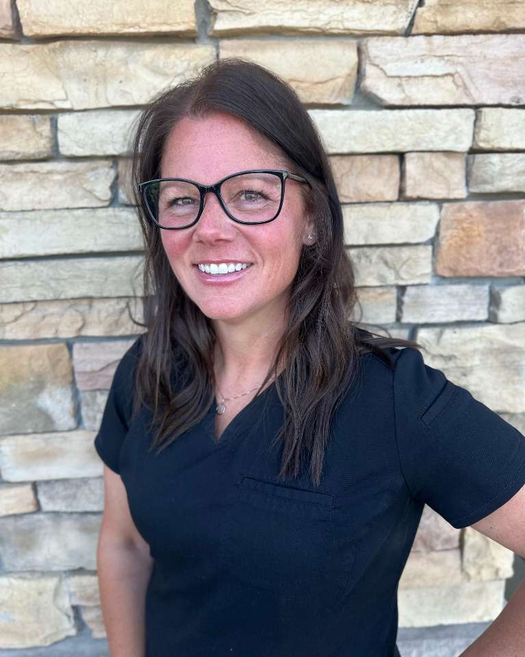 Missy, a dental assistant, stands and smiles | dentist in evansville indiana